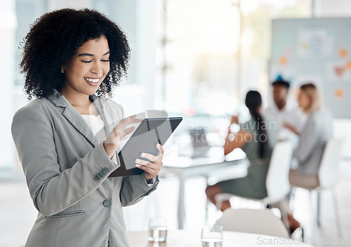 Image of Business woman working on a digital tablet doing research while in a team meeting in the office. Corporate employee reading information on the company website with technology in a conference room.