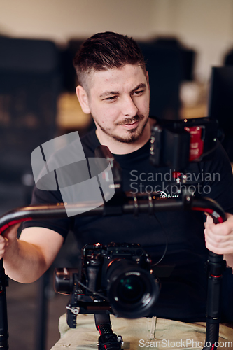 Image of A professional videographer using modern equipment to capture compelling visuals, showcasing expertise and creativity in the art of video production.