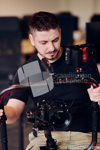 Image of A professional videographer using modern equipment to capture compelling visuals, showcasing expertise and creativity in the art of video production.