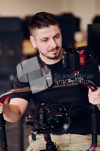 Image of A professional videographer using modern equipment to capture compelling visuals, showcasing expertise and creativity in the art of video production.