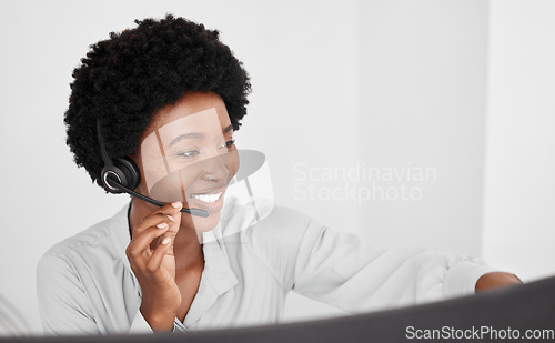 Image of Call center consultant in communication online on computer, consulting with people on the internet and support in customer care job at telemarketing company. Happy African receptionist on phone call