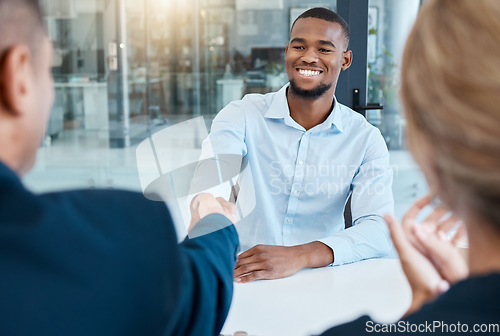 Image of Shaking hands, interview and business people give a handshake after hiring a new company employee. Onboarding, thank you and management welcome young African worker a job promotion in office meeting