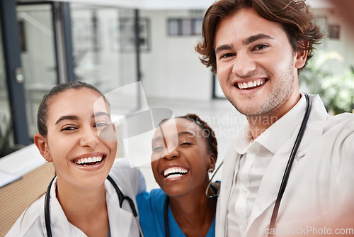 Image of Healthcare, hospital and doctors taking selfie, bonding while working together and having fun. Medical intern posing for a picture, smiling and laughing, enjoying diverse friendship at the workplace