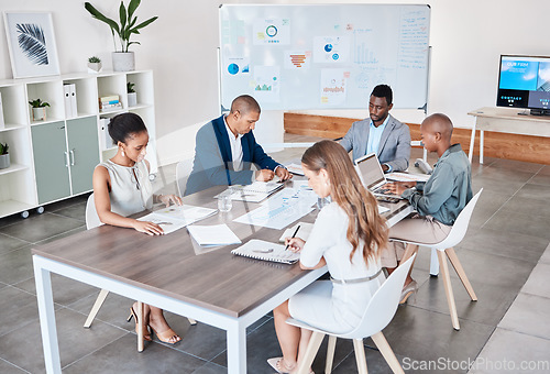 Image of Business people working on documents and laptop at a office boardroom table. Group of professional, diversity and analysts browsing ideas online and planning and teamwork to prepare in a b2b meeting