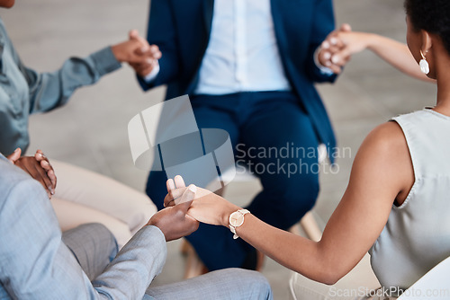 Image of Support, trust and collaboration with a group of business people holding hands while sitting in circle for a team building workshop. Pray, motivation and diversity in a corporate office or workplace
