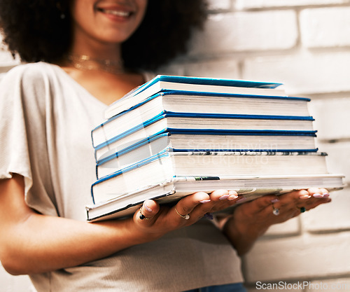 Image of Education, knowledge and learning student with books for studying, research or assignment on a white wall. Black scholarship, geek or nerd girl with stack of university library textbooks for reading