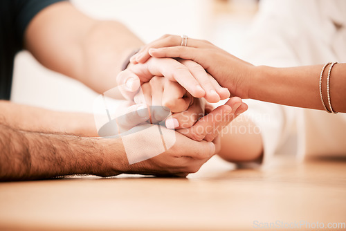 Image of Support, care and family holding hands together at table to show empathy, love and hope. Closeup of connection, trust and friendship in community rehab group showing compassion and gratitude.