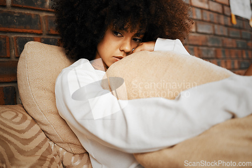 Image of Sad, depressed and lonely black woman with mental health problems hugging a pillow at home. Portrait of a African afro female in depression, stress and anxiety feeling unhappy living alone in a house