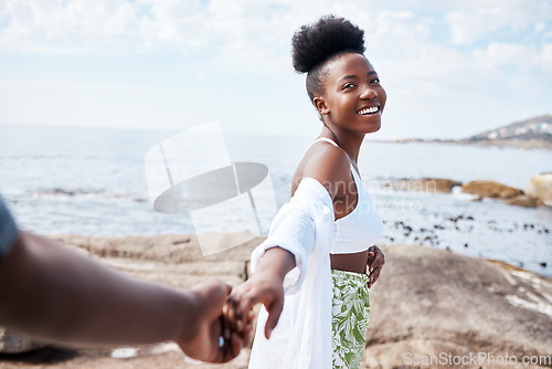 Image of Summer, sea and smile, a black couple holding hands and walking on the beach. Nature, love and freedom on romantic weekend, a black woman and man by the ocean. Holiday, adventure and romance with POV