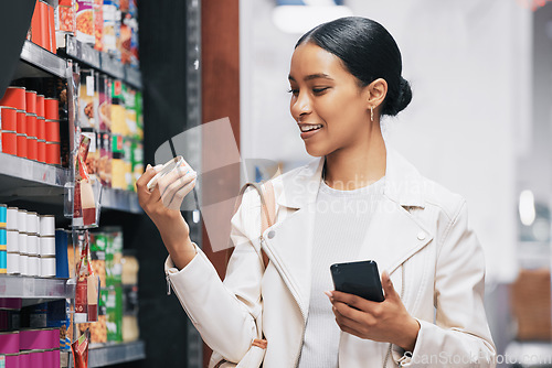 Image of Supermarket, shopping and customer with smartphone check price, label or product information online. Retail consumer woman with food or grocery checking discount code or sales choice on a digital app