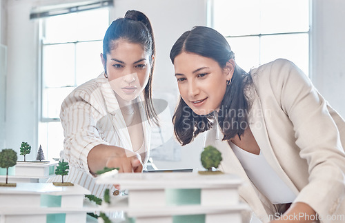 Image of Architect, team and engineer meeting while women discuss 3d architectural model vision. Teamwork and collaboration while talking and planning construction building prototype design project in office