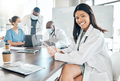 Image of Healthcare, diversity and black woman doctor with tablet at meeting with team of doctors. Success, communication and collaboration, proud female medical worker and leader in the field of medicine.