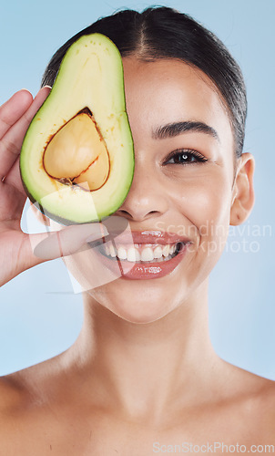 Image of Avocado, wellness and skincare woman portrait on blue studio background and mockup. Young model with natural organic nutrition diet for face and healthcare with green, clean and healthy lifestyle