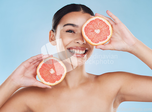 Image of Beauty, health and woman with clear skin and a grapefruit with nutrition and vitamins in a studio. Girl with a healthy, wellness and fresh skincare and selfcare routine with organic citrus fruit.