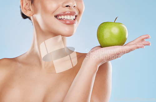 Image of Health, beauty and woman with an apple and a wellness, healthy and organic lifestyle in studio. Girl with clear skin and fresh skincare routine holding a fruit with vitamins and nutrition for a diet.