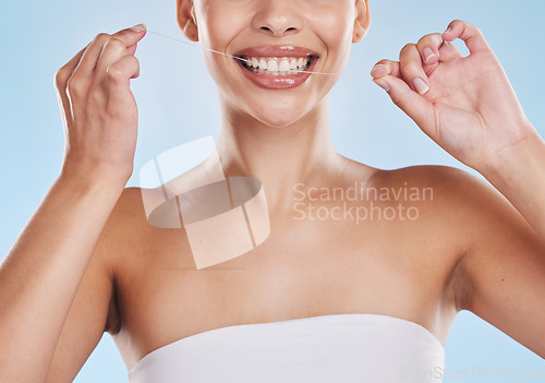 Image of Dental floss, teeth and healthy smile with a beautiful young woman flossing for oral hygiene and gum health. Closeup of a happy female cleaning her mouth during her selfcare wellness routine