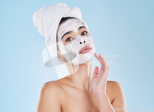 Image of Skin care, face wash and mask on woman in studio with blue background and mockup. Young model in bathroom towel in a self care, beauty or cosmetic portrait for skin health and wellness with mock up