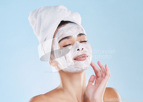 Image of Skincare woman, beauty facial mask and cosmetics after fresh shower, bathroom grooming routine and bodycare on blue background. Feminine face, clean spa pores and healthy pamper treatment complexion