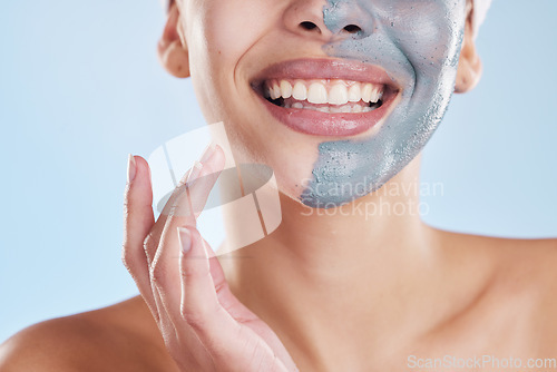 Image of Skincare, beauty and face mask with a beautiful woman taking care of her clean, healthy and glowing skin. Closeup smile, wellness and charcoal or clay exfoliate product during routine treatment