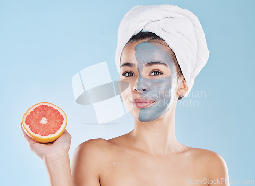 Image of Woman, skincare and grapefruit face mask, organic beauty and wellness for healthy antiaging, fresh detox and natural clean facial on blue background. Portrait, feminine grooming and model bodycare