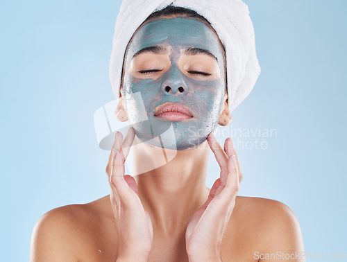 Image of Skincare, beauty and face mask on a woman while doing her wellness routine in a studio. Latina girl with fresh, body care and hygiene lifestyle doing selfcare facial treatment to relax after a shower