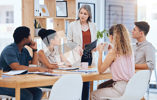 Image of Ceo woman consulting young team, explain business strategy and professional working together. Group of employees listen to boss, corporate office manager planning meeting and solution focused staff