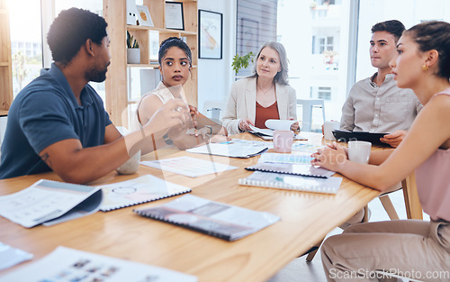 Image of Teamwork, collaboration and planning with business people in a creative meeting, discuss strategy in a corporate office. Diverse, serious designer united on a goal or mission, sharing idea and vision