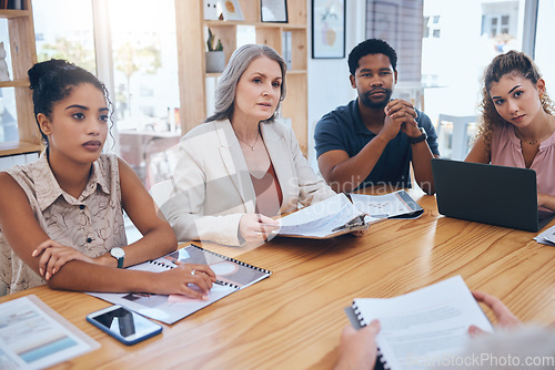 Image of Business people meeting to talk about data paperwork in an office. Group of marketing professional workers planning a strategy while collaborating to discuss ideas for a project in a creative startup