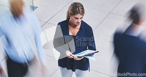 Image of Business employee reading paperwork, crowd of people walking fast and serious corporate white woman stopping in lobby hall. Busy office building, hold company documents and people traffic blur motion