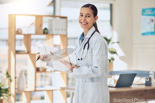 Image of Doctor, healthcare and consulting with a medical or health professional reading paperwork in the hospital. Trust, insurance and medicine with a woman in a clinic for health, wellness and medicare