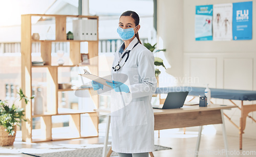 Image of Insurance checklist and covid healthcare doctor with face mask and portrait while working with medical paperwork in an office. Trust and vision of a covid 19 expert woman checking vaccination results