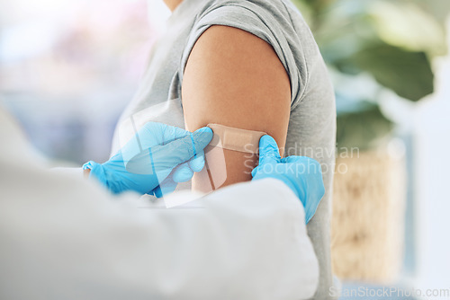 Image of Covid virus vaccination, vaccine and doctor hands with plaster on patient arm in a medical hospital or clinic. Healthcare worker help, trust and safety flu shot antigen for protection against disease