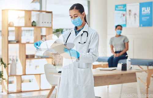 Image of Doctor with mask and patient for medical test results documents at hospital in covid or corona global pandemic. Consulting healthcare woman worker with health insurance paperwork of sick girl