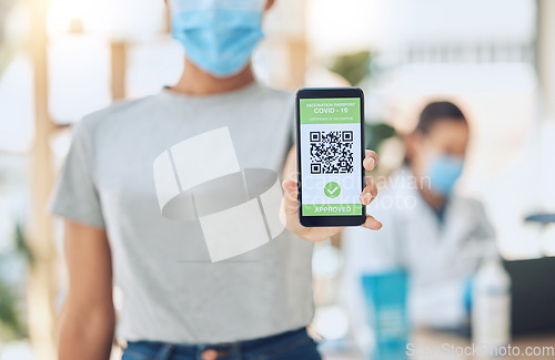 Image of QR code for covid vaccine passport and certificate at covid 19 vaccination center or site for health and safety verification. Hands of young girl with smartphone for approval or confirmation document