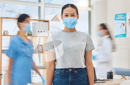 Image of Covid, mask and medicine with a woman in the hospital and a doctor and nurse in the background for consulting, healthcare and wellness. Medical, trust and help with a female patient in a clinic