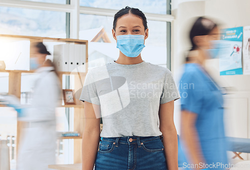 Image of Compliance, healthcare and covid rules at hospital with a happy patient coming for a checkup with busy doctors. Portrait of a young woman looking excited about the corona vaccine and treatment