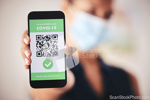 Image of Covid passport, QR code and phone in the hand of a woman refugee or passenger ready for immigration and travel. Closeup of 5g mobile technology for safety during the global corona virus epidemic