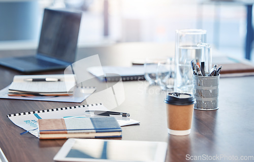 Image of Desk, empty office workspace on a wooden desk or table in a corporate boardroom. Laptop or computer in a digital marketing agency or IT company with notebooks and a coffee cup