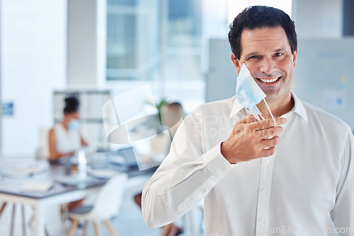 Image of Covid, health and freedom, mask off for man in office after lockdown. Portrait of a happy businessman putting a face mask on to curb spread of virus in workplace and protect employees from infection.