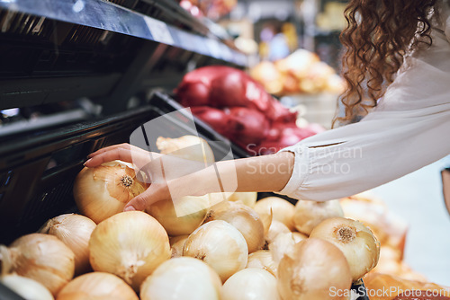 Image of Vegetables, grocery shopping and health while a customer choose fresh onions in supermarket or greengrocer store. Close up hands of woman buying vegan food groceries before inflation at retail market