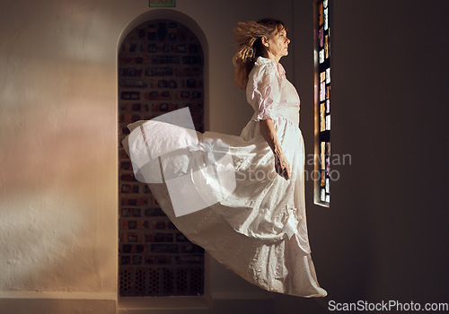 Image of Ghost of senior woman, looking at stained glass and floating over floor of building or cathedral. Elderly soul, phantom or dead spirit staring at beautiful window at a chapel or church after funeral