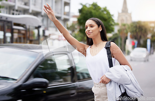 Image of Business woman call a taxi or transport in the city street in the morning while commute to work. Friendly corporate worker hand and arm wave for a cab in a urban town and road in busy traffic