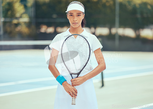 Image of Tennis player, athlete and sports woman training and practising for a match of game with a racket on an outdoor court. Serious, active and fitness girl ready for wellness, exercise and competition