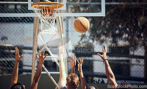 Image of Basketball, sports and fitness with friends on a court for sport, health and exercise outside during summer. Training, workout and recreation with a team of players playing a game or match outdoors