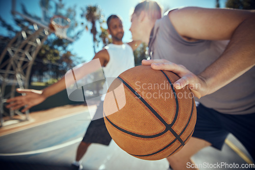 Image of Basketball, competitive sports and practice match with men, players or friends playing a game at an outdoor court. Athletes staying fit and enjoying leisure activity with a ball while trying to score