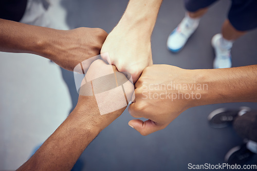 Image of Teamwork, hands and collaboration with people standing in a circle or huddle in support, unity or solidarity. Team, group of community with fists joined in union together from above and closeup