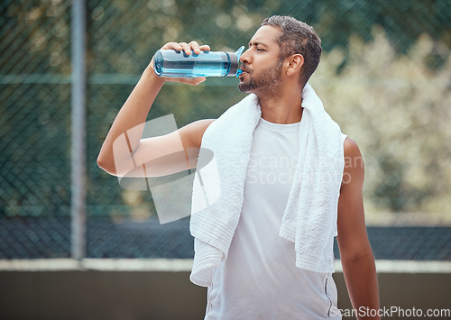 Image of Sports, fitness and man on break drinking water after a workout, training session or exercise. Health, athlete and male trainer resting with refreshing liquid after playing a sport, running or cardio