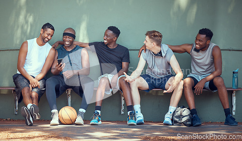 Image of Basketball, sport and friends with a team of men sitting on a bench after training, practice or a game. Teamwork, phone and exercise with a group of basket ball players outside on a sports court