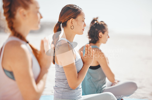 Image of Women doing meditation class for wellness on beach, spiritual training exercise for calm and motivation for healthy lifestyle at the ocean in nature. Yoga group on summer travel holiday in Mexico