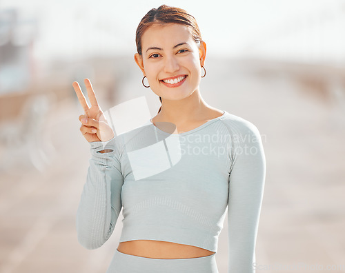 Image of Peace sign hand, fitness woman or motivation for wellness health goals in exercise, training or sports workout. Happy smile portrait of personal trainer, cool gesture and athlete runner on background